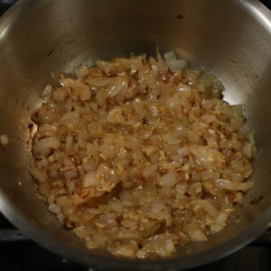 Sautéed diced onion in pot.